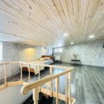 The second level includes two single beds.